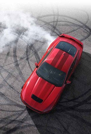 Overhead view of a 2024 Ford Mustang® model with tire tracks on pavement | Midland Ford in Midland MI